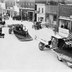 Bridge Street in 1929, the east side of the 300 block where East Park is today. A winter parade featured the latest snow removal equipment of the county road commission. The destruction by fire of the Hotel Charlevoix, top left, in 1935 was the impetus for creating a downtown park. All of these buildings came out by 1936, except for two holdouts on either end, when East Park began to be developed into the crown jewel of Charlevoix’s park system. The photo was taken from the second floor of the Masonic Temple building at the Mason Street corner. 1929 Winter Parade