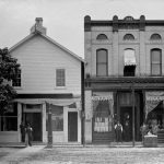 In the early 1870s Dr. George W. Crouter came to Charlevoix from Grand Rapids. Within two years he built his drugstore and dental office (left) at 214 Bridge Street. The first telephone exchange went into its second story. The building is still in use today, the last of the downtown wooden structures of the early days. In 1882 pioneer and banker Archibald Buttars built a brick structure (right) occupied for many years by George W. Miller, clothier. 214 Bridge Street