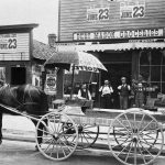 Next door to Conner’s shoe shop stood Bert (sometimes spelled Burt) Mason’s grocery and household goods store at 310 Bridge Street. A delivery wagon was part and parcel of the business, for any grocery without delivery service was of short duration. Dobbin never ran out of gas and was always easy to start in winter. Fuel consumption data was never recorded. Emissions, however, were difficult to control. The building was torn down in 1934. From left, in 1909: Bert Mason, Arthur Alcox, Morris Ackert, and Jimmy Conner. Bert's Grocery Store 1909