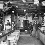 Bert Mason’s interior. From the ceiling hang brass-banded oak buckets, coffee pots, washboards, brooms, lanterns, hoes, and frying pans. Does any big box store today show as much character? Interior of Bert Mason's