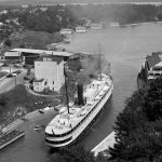 The “Greyhound of the Great Lakes,” the mighty Manitou was an opulent gliding luxury hotel that carried nearly 400 passengers. The Manitou made the Chicago-direct-to-Charlevoix-Harbor Springs-Mackinac Island and back route three times a week, calling at Charlevoix three times on the way up and three on the way down. The first leg up took twenty hours non-stop, a record at the time. On her first visit to Charlevoix on June 21, 1896, three years after she was launched, the whole town turned out to welcome her into Round Lake. The Manitou